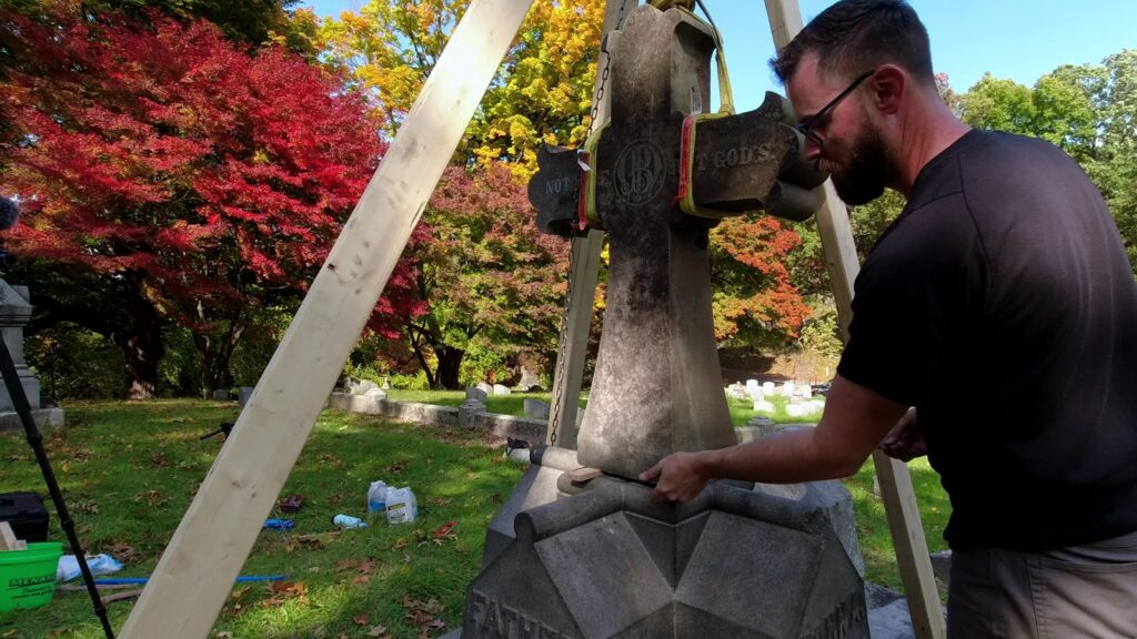 Lowering the cross onto the top of the monument