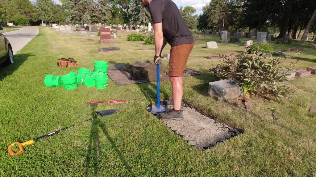 Wade tamping a cellular confinement base filled with crushed stone