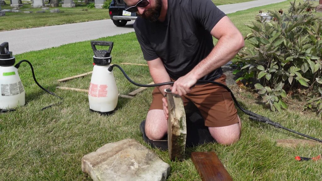 Wade cleaning a marble piece with a sprayer