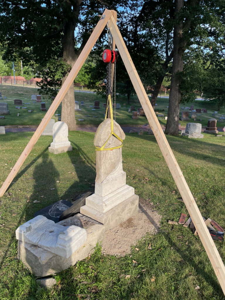 Wooden tripod and chain hoist lifting the marble tablet